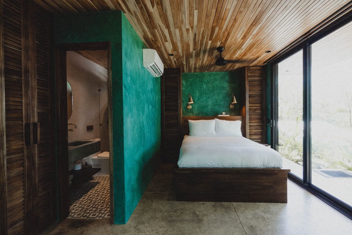 Brisa room with teal feature wall and corner windows