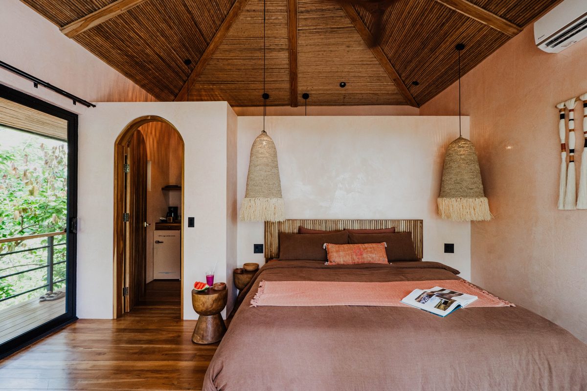 Nube suite with arched doorway and king bed