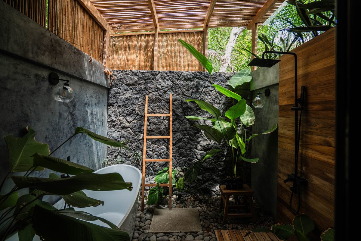 Rio suite's private outdoor stone bath among tropical plants
